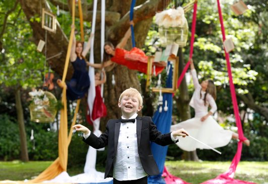 NO REPRO FEE 11/08/2015. Culture Tree as Culture Night 2015 Launches. Today, Tuesday 11th August, Culture Night participants opera singer Aoife Gibney and aerial artists from Aerial Cirque officially launched Culture Night 2015 in Merrion Square Park with a little help from young conductor Cillian Byrne. Pictured in front of a tree adorned by all things cultural, Culture Night participants warmed up for an evening of nationwide exploration, experience and enjoyment that revolves around you as details of the programme were unveiled. Picured is Cillian Byrne age6. Photography: Sasko Lazarov/Photocall Ireland